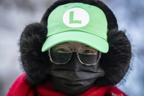 A supporter of Luigi Mangione wears the Nintendo character Luigi’s green hat outside a New York courthouse in February 2025.
AP Photo/Stefan Jeremiah
