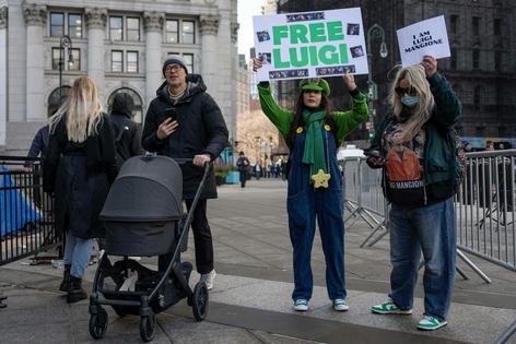 Supporters of Luigi Mangione raise signs outside the Manhattan federal courthouse in New York in January 2026.
AP Photo/Yuki Iwamura