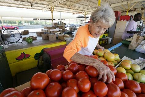 Fans can help circulate air, but on a hot day they do little for people working in a Mississippi farmer's market AP Photo/Rogelio V. Solis