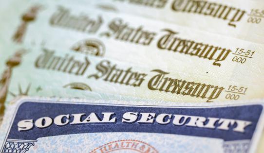 In this photo illustration, a Social Security card sits alongside checks from the U.S. Treasury on Oct. 14, 2021, in Washington, D.C. (Kevin Dietsch/Getty Images/TNS)