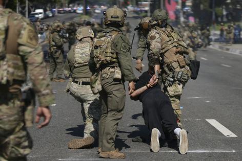 Police detain a man during a June 2025 protest in Paramount, Calif., where federal immigration authorities had conducted operations. AP Photo/Eric Thayer