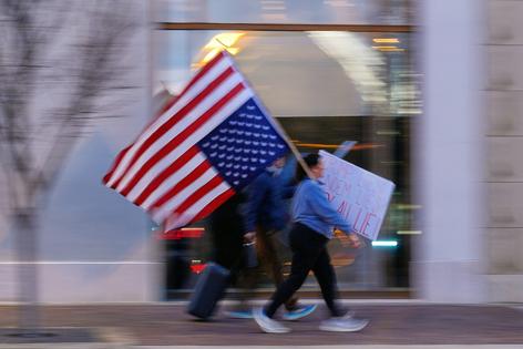 Protesters walk through a shopping center after attending a demonstration for Renee Good, who was fatally shot by an ICE officer in Minneapolis in January 2026.
              AP Photo/Charlie Riedel
