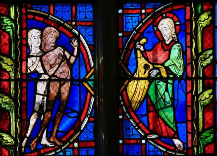 Adam and Eve - Stained Glass in Tours Cathedral. Stained glass window depicting Adam and Eve in the Cathedral of Tours, France. Dreamstime/TCA