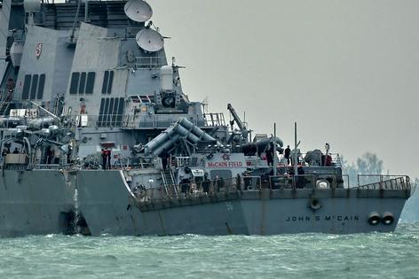 The USS John S. McCain appears with a hole on its portside after a collision with an oil tanker on Aug. 21, 2017.
Roslan Rahman/AFP via Getty Images
