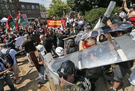 White nationalist demonstrators clash with counterdemonstrators at the entrance to Lee Park in Charlottesville, Va., on Aug. 12, 2017.  AP Photo/Steve Helber