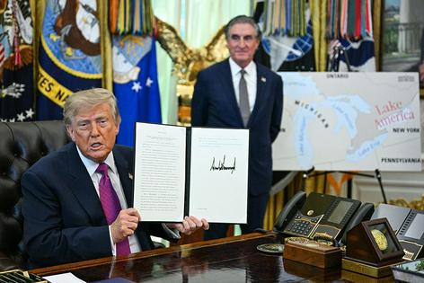 TOPSHOT - US President Donald Trump, alongside Secretary of the Interior Doug Burgum, displays an executive order he signed that aims to rename Lake Ontario to Lake America in the Oval Office of the White House in Washington, DC, on August 27, 2026. President Donald Trump announced Thursday that he is renaming Lake Ontario -- a large body of water shared by the United States and Canada -- 