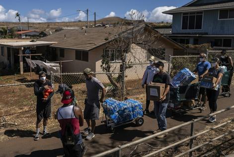 Volunteers deliver food and bottled water to elderly residents impacted by the 2023 wildfires in Lahaina, Hawaii.
              AP Photo/Jae C. Hong