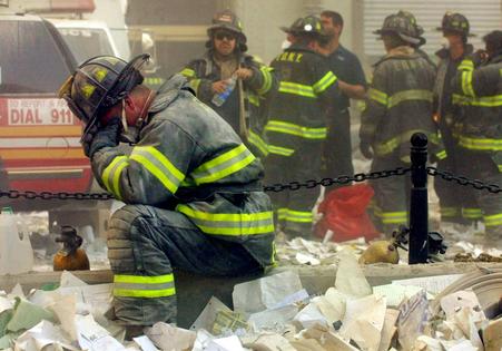 Firefighter Gerard McGibbon prays after the World Trade Center buildings collapsed Sept. 11, 2001, killing some 3,000 people.
              Mario Tama/Getty Images