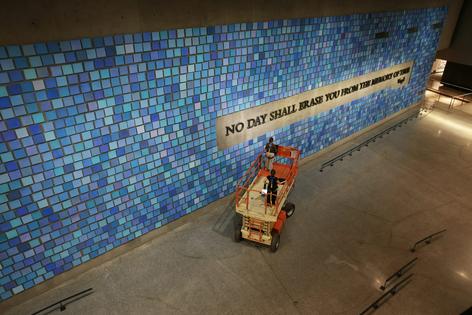 'No Day Shall Erase You From the Memory of Time,' a phrase written by the Roman poet Virgil, is displayed on a wall at the 9/11 Memorial Museum.   Spencer Platt/Getty Images