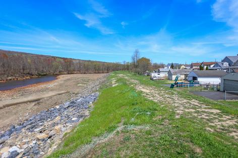 The levee in Duryea, Pa., which sits on the banks of the Lackawanna River, was built in the 1970s. The local flood protection authority wants to raise it about 3 feet to protect the small rural town from flooding.
              Jason Ardan/The Citizens' Voice via Getty Images