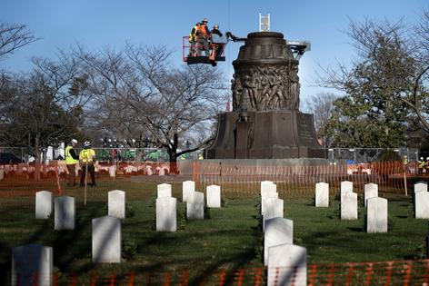Graves of Confederate veterans are seen as workers dismantle the Confederate Memorial at Arlington National Cemetery on Dec. 20, 2023, in Arlington, Virginia.  (Brendan Smialowski/AFP/Getty Images/TNS)
