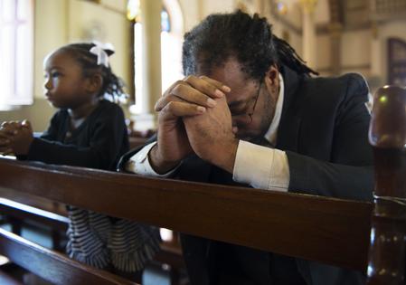 Christians praying. Dreamstime/TCA