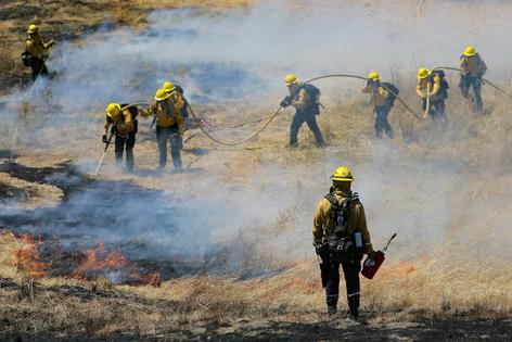 Firefighters practice their skills while conducting a prescribed burn to remove dry, flammable vegetation that could fuel intense, destructive fires. Prescribed burns can also make fighting future fires there safer.
Heather Diehl/Getty Images