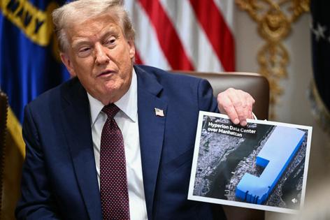 President Donald Trump holds an image showing the size of Meta’s new data center during a cabinet meeting on Aug. 26, 2025. (Mandel Ngan/AFP via Getty Images/TCA)