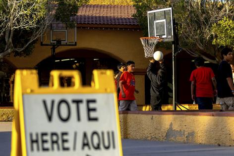 Kids play outside a polling precinct in Guadalupe, Ariz., in 2024.
              AP Photo/Ty ONeil