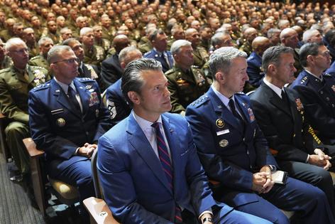 Defense Secretary Pete Hegseth, center, and U.S. military leaders listen to President Donald Trump speak at Marine Corps Base Quantico in September 2025.
AP Photo/Evan Vucci