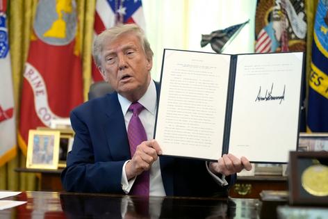 President Donald Trump holds up a signed executive order in the Oval Office in August 2026. AP Photo/Manuel Balce Ceneta