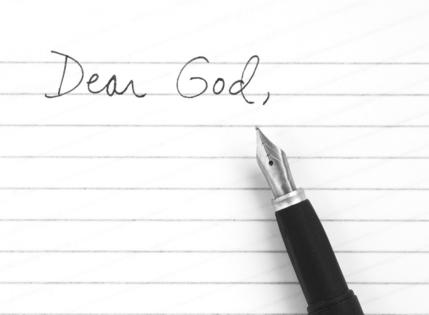Dear God. Writing a letter to God for guidance and prayer. Dreamstime/TCA