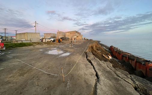 A coastal bluff failure in Utqiaġvik, Alaska, in August 2024 shows cracks and the narrow distance between the eroding edge and buildings.
              Ming Xiao