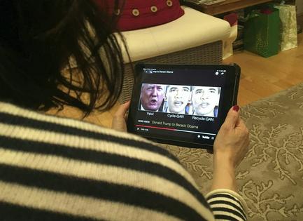 A woman views a manipulated video in January 2019 that changes what is said by President Donald Trump and former President Barack Obama, illustrating how deepfake technology can deceive viewers. Robe LeverAFP via Getty Images