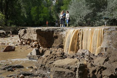 Boulder, Colo., residents look at flooding damage after heavy rains in 2013.
              Marc Piscotty/Getty Images