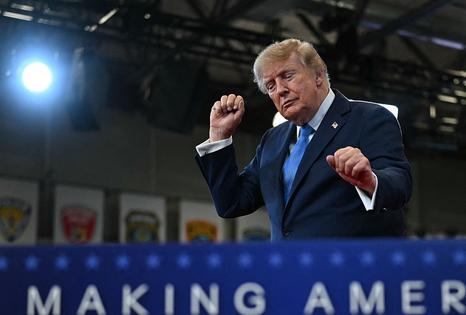 US President Donald Trump dances as he departs after delivering remarks at the Nassau County Police Academy Center for Training and Intelligence in Garden City, New York, on August 14, 2026. (Photo by Kent NISHIMURA / AFP via Getty Images)
