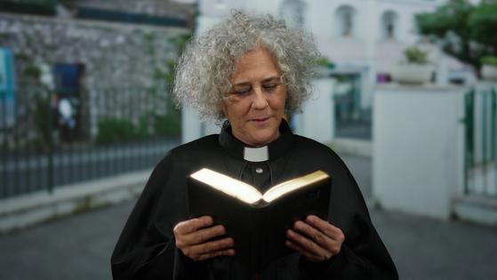 Clergy reading Bible. Dreamstime/TCA
