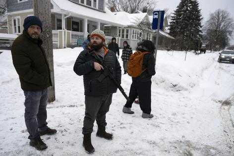 A resident in Falcon Heights, Minn., holds an AR-15 assault rifle on Jan. 18, 2026.
Roberto Schmidt/AFP via Getty Images