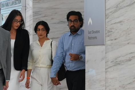 Omar Ahmed, right, and his wife, Nausheen Gilkar, center, arrive for a court hearing in Dallas on Aug. 25, 2026, in their fight with their surrogate, McKenna West.
              AP Photo/LM Otero