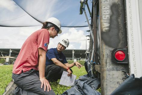 Engineers Elaina Sutley and Arindam Chowdhury examine the anchoring system of a mobile home after a wind test.
              Margi Rentis/Florida International University