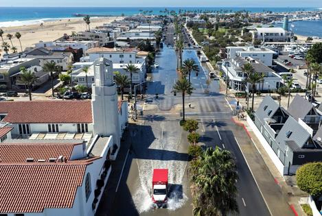 An emergency vehicle drives through coastal floodwaters amid strong waves and high tides generated by Tropical Storm Rachel on Oct. 9, 2026, in Newport Beach, Calif.
              Mario Tama/Getty Images
