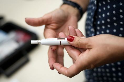 Heated tobacco products heat cigarettes without burning them, releasing fewer toxins – but harmful ones nonetheless.
              Fabrice Coffrini/AFP via Getty Images