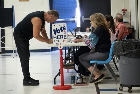 Residents check in to vote in the primary at a polling place at Morgan Elementary School on Aug. 4, 2026, in Shelby, Mich.
              Scott Olson/Getty Images