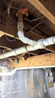 This PVC tee fitting connects a toilet to the main drain line. There are two serious code violations here. This is why you need to have a knowledgeable inspector look at all mechanical systems in any house you intend to purchase. (Tim Carter/Tribune Content Agency). TNS