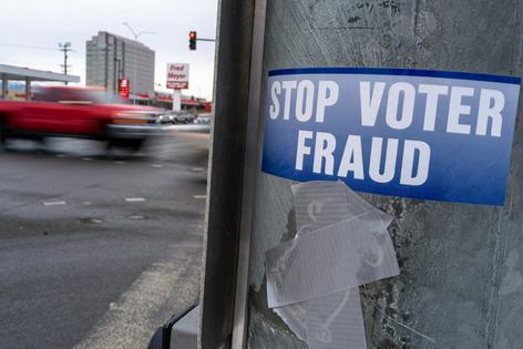 A sticker on a lamppost warns of voter fraud on Nov. 7, 2022, in Anchorage, Alaska. Spencer Platt/Getty Images