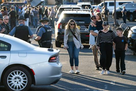 People leave a family meeting area following a shooting at Silver Rail Elementary School on Oct. 15, 2026, in Bend, Ore. AP Photo/Joe Kline
