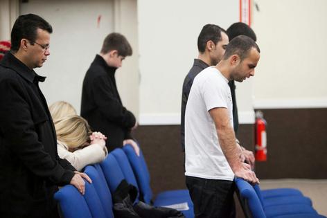 Members of the First Brazilian Church of Boston pray during a Sunday evening service in 2013.
              Kelvin Ma/MediaNews Group/Boston Herald via Getty Images