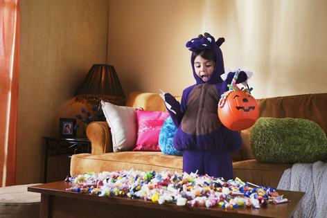 It's probably best to enjoy your Halloween spoils in moderation. Jupiterimages/The Image Bank via Getty Images
