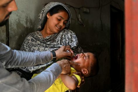 In Pakistan, where wild polio still has not been eliminated, health workers go door to door vaccinating young children. ARIF ALI/AFP via Getty Images