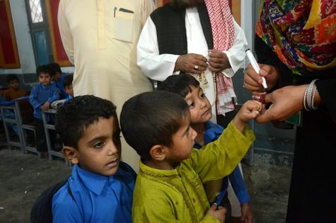 A Pakistani health worker marks the pinkie of a child she has just vaccinated for polio.
              Pacific Press/LightRocket via Getty Images