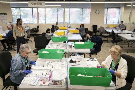 Election workers open midterm elections ballots at the King County Elections headquarters on Oct. 23, 2026, in Renton, Wash.
              David Ryder/Getty Images