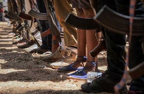 Newly released child soldiers participate in a 2018 ceremony in South Sudan, part of a program to help them return to civilian life. Children typically surrender their weapons at such ceremonies.
              Stefanie Glinski/AFP via Getty Images