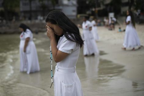 Devotees pray during an Umbanda religious ceremony at Urca beach in Rio de Janeiro on Dec. 30, 2023.
AP Photo/Bruna Prado