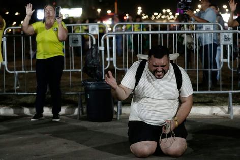 Supporters of Brazilian presidential candidate Flávio Bolsonaro pray in Brasilia after he lost the runoff election on Oct. 25, 2026.
AP Photo/Bruna Prado