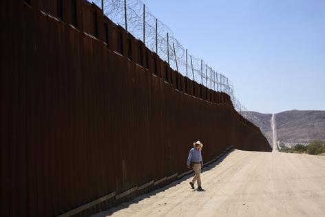 A volunteer walks along the U.S.-Mexico border near Jacumba Hot Springs, Calif., on June 5, 2025. AP Photo/Gregory Bull