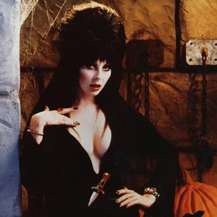 Bang Showbiz / Cassandra Peterson portrays horror hostess Elvira, Mistress of the Dark.