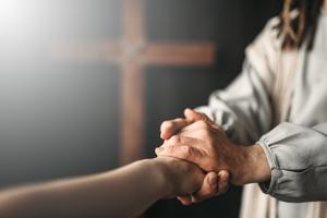 Jesus Christ gives a helping hand to the faithful. Dreamstime/TCA
