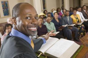 Preacher at altar with Bible preaching. Dreamstime/TCA