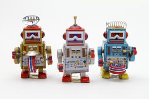 A marching band of 3 tin toy robots in gold, silver and blue. Dreamstime/TCA