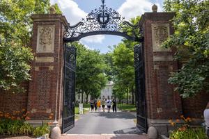 CAMBRIDGE, MASSACHUSETTS - JUNE 29: People walk through the gate on Harvard Yard at the Harvard University campus on June 29, 2023 in Cambridge, Massachusetts. The U.S. Supreme Court ruled that race-conscious admission policies used by Harvard and the University of North Carolina violate the Constitution, bringing an end to affirmative action in higher education. (Photo by Scott Eisen/Getty Images)
